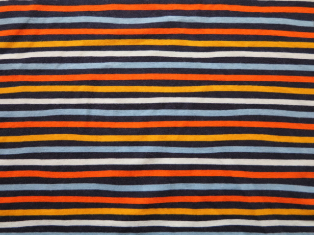 Tissu jersey à rayures jaune, orange, bleue, noire certifié GOTS